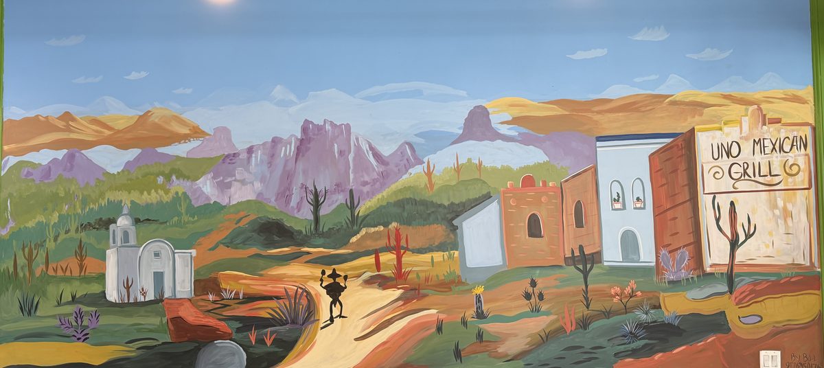 The hand-painted desert mural along the dining room wall